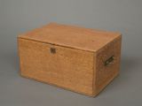 an old wooden box sitting on top of a gray surface