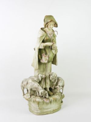 figurine of a boy with sheep and sheepdogs on a white background