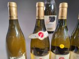 several bottles of wine are lined up on a table