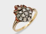 a close up of a gold ring with a flower design
