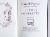 an open book with a drawing of a man ' s face on it
