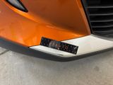the front bumper of a car with a sticker on it