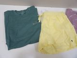 two shirts and a skirt are sitting on a white table