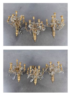 two pictures of a pair of gold and crystal sconces hanging from a wall