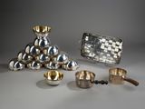 several silver objects are sitting on a table with a silver purse