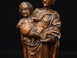 a statue of a woman holding a child in her arms