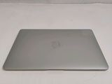 an apple macbook air laptop computer sitting on top of a white surface