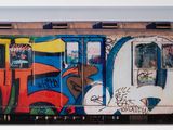 a picture of a train with graffiti on the side of it