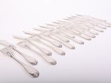 a lot of forks and spoons on a white surface