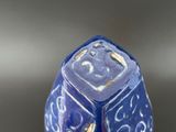 a close up of a blue and white dice on a table