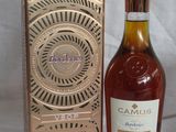 an image of a bottle of brandy next to a box