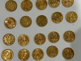 a lot of gold coins on a white surface