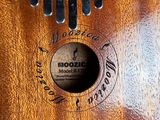 a close up of a wooden comb with a logo on it