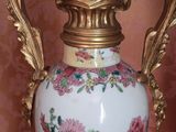 a vase that is sitting on a table in front of a wall