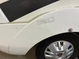 a close up of a white car with a sticker on it
