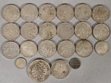 several coins are arranged in a heart shape on a white surface