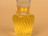 yellow glass vase with a clear lid on a beige background