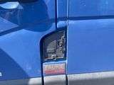 a blue van that has a sticker on the side of it