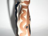 a vase that is sitting on a white surface