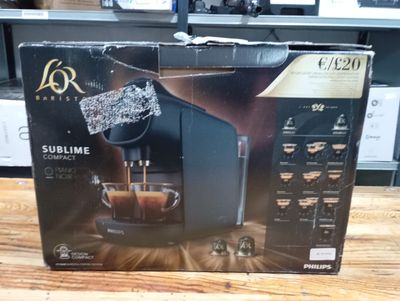 packaging of a coffee machine sitting on top of a wooden table
