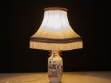 a lamp that is sitting on a table with a lamp shade on it