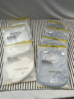 quatre paquets de masques Exaku sur un tissu rayé