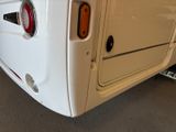a close up of the rear end of a white bus