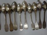 six spoons are lined up in a row on a table