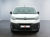 the white van is parked in a large room with a black floor
