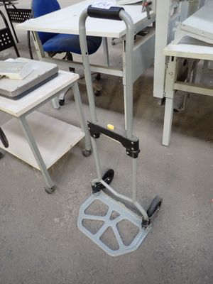 a desk with a chair and a table with a laptop on it