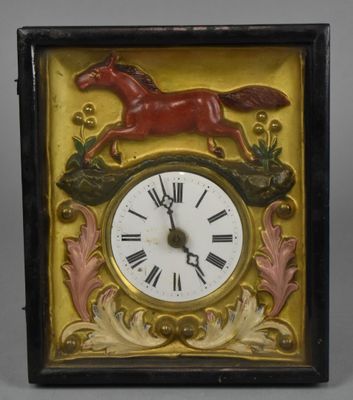 a picture of a clock with a horse on it