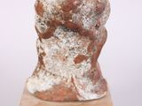 an image of a sculpture of a man ' s head on a wooden base