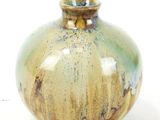 a small vase that is sitting on a white surface
