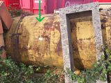 a yellow barrel with a green arrow pointing to it