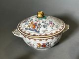 a white bowl with a lid that has a bird on it