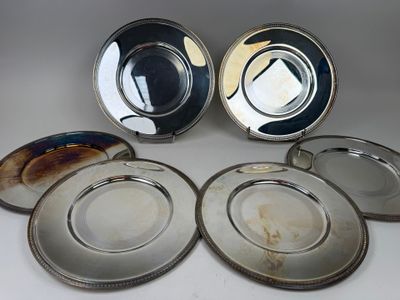 six silver plated plates with a silver rim and a silver rim