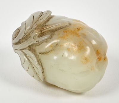 a white stone with a leaf design on it