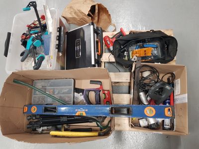 a box full of assorted tools on the floor