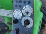 a close up of a green machine with gauges on it