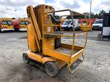 a yellow scissor sitting in the middle of a parking lot