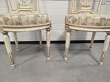 pair of white painted chairs with upholstered upholstered backs