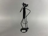 black metal cat figurine on stand on white background