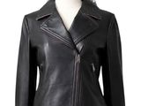 the woman is wearing a black leather jacket and pink skirt