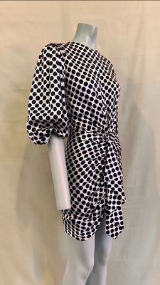 the mannequin is wearing a black and white dress with black and white squares