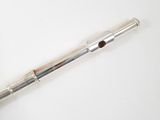 a flute that is sitting on a white surface