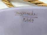 a close up of a plate with a rope on it