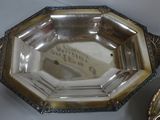 a silver plate and a silver bowl on a table