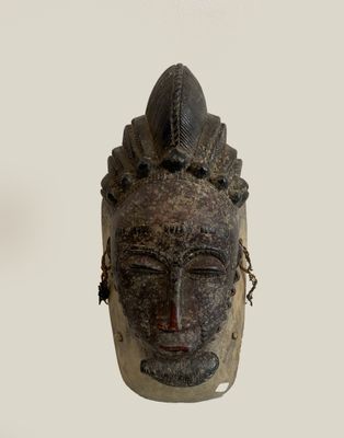 an image of a wooden mask with a chain around it ' s neck
