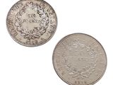 a close up of two silver coins on a white background