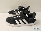 a pair of black and white shoes on a white surface
